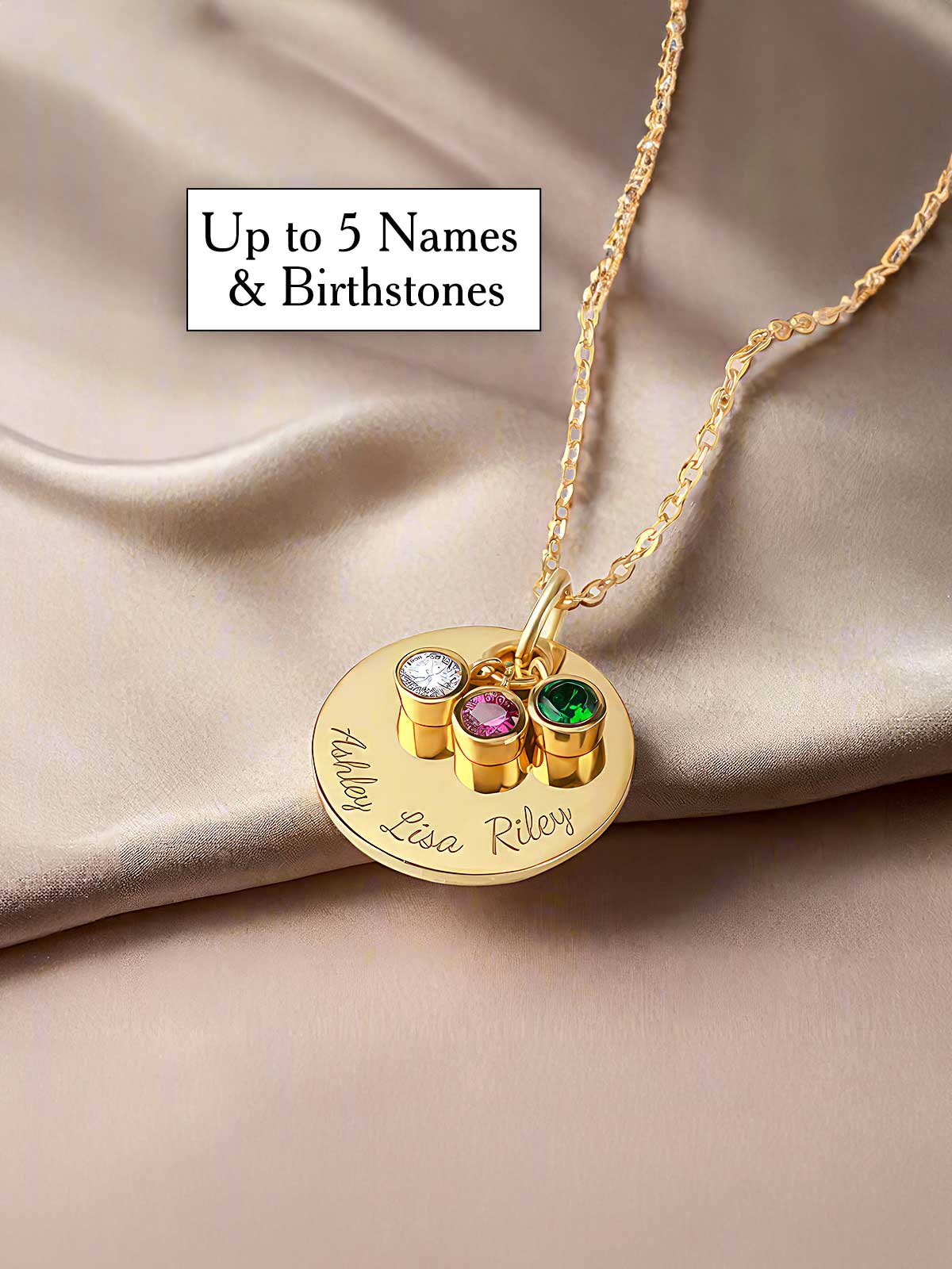 a gold necklace with three names and two gems