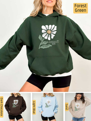 a woman wearing a green hoodie with a flower on it