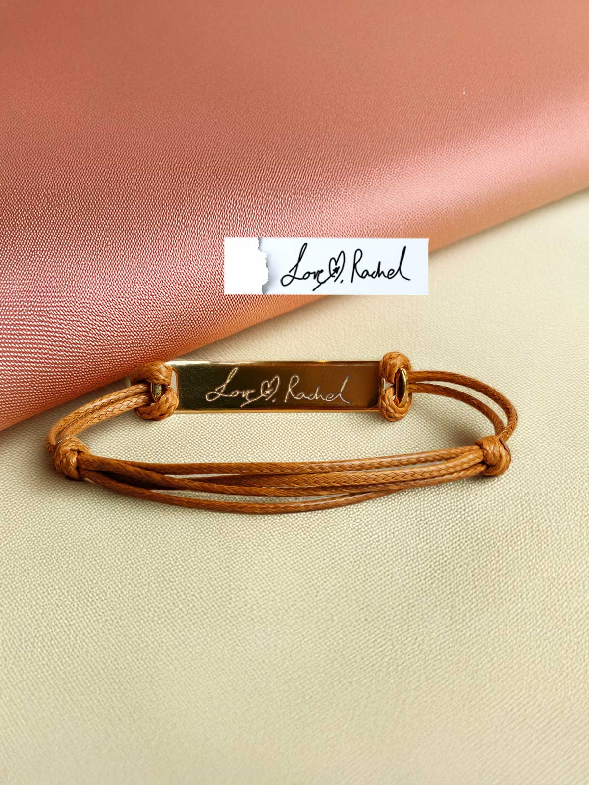 a leather bracelet with a name tag on it