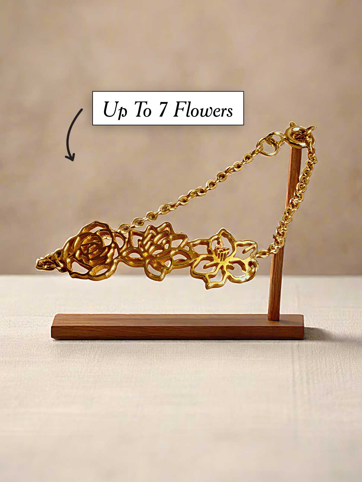 a piece of gold jewelry on a wooden stand