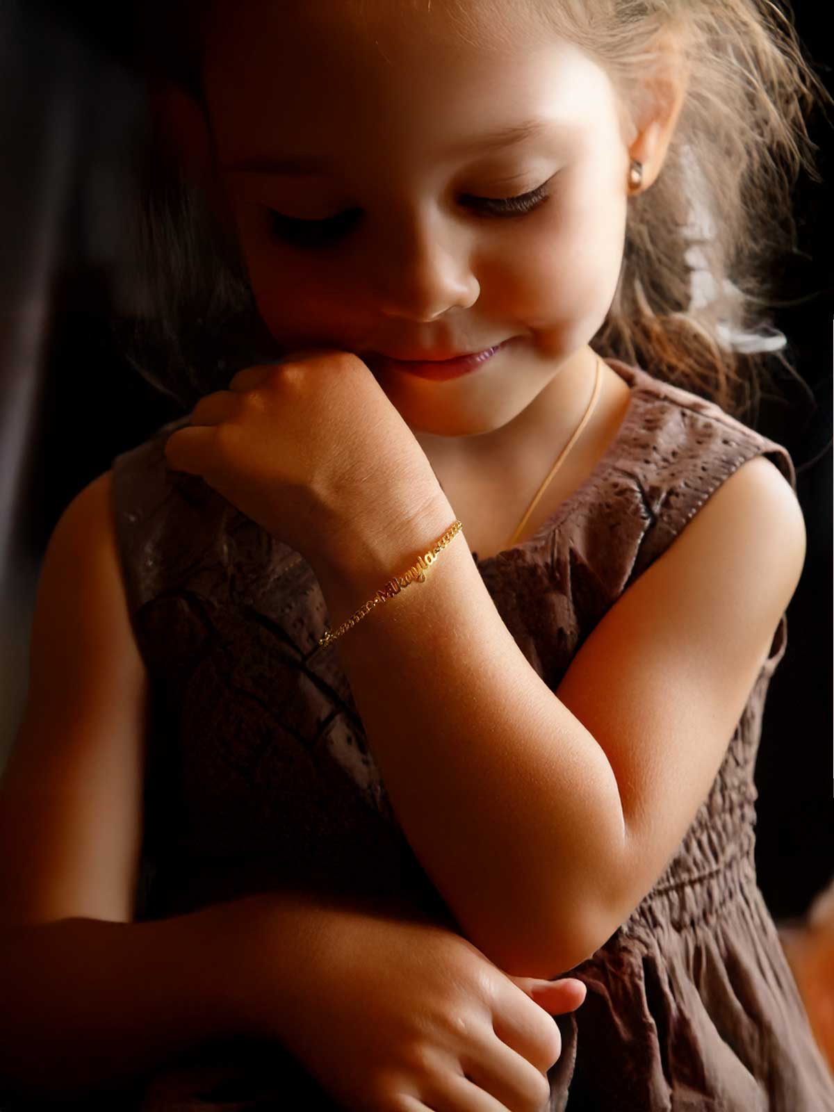 a little girl that is wearing a bracelet