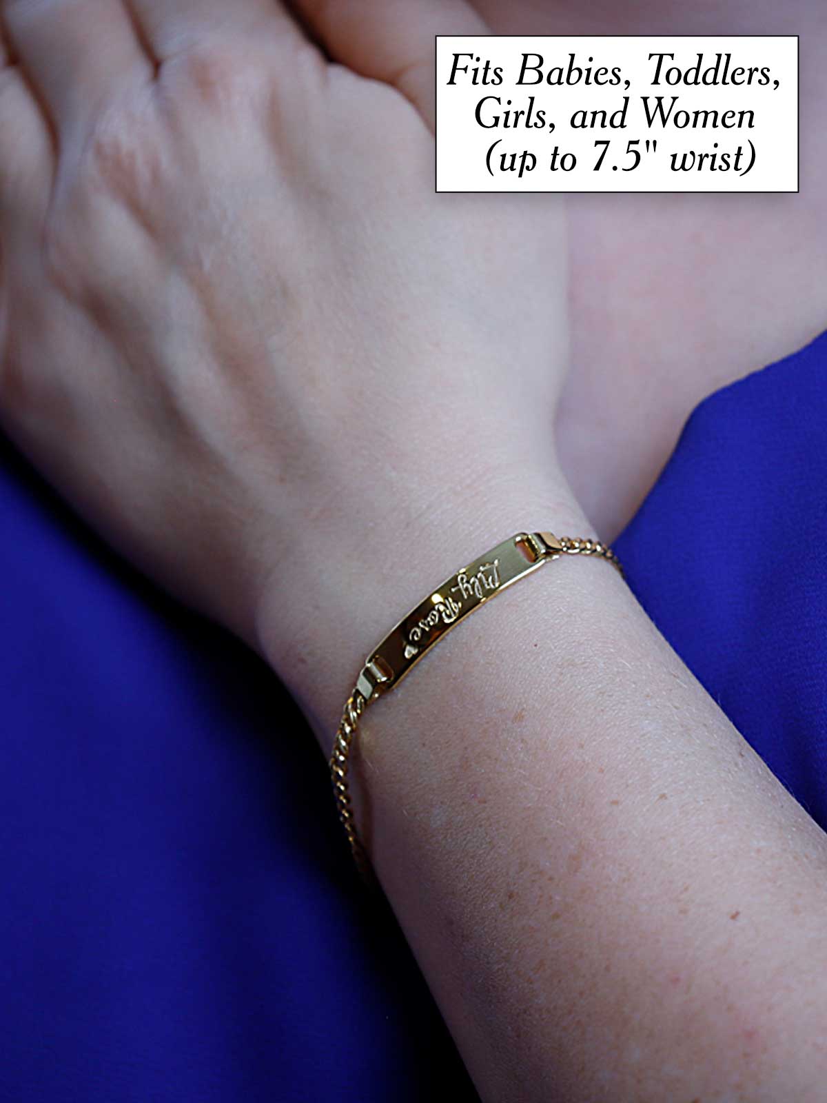 a woman's arm with a gold bracelet on it