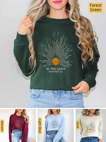 a woman wearing a green sweatshirt with the words be the light on it