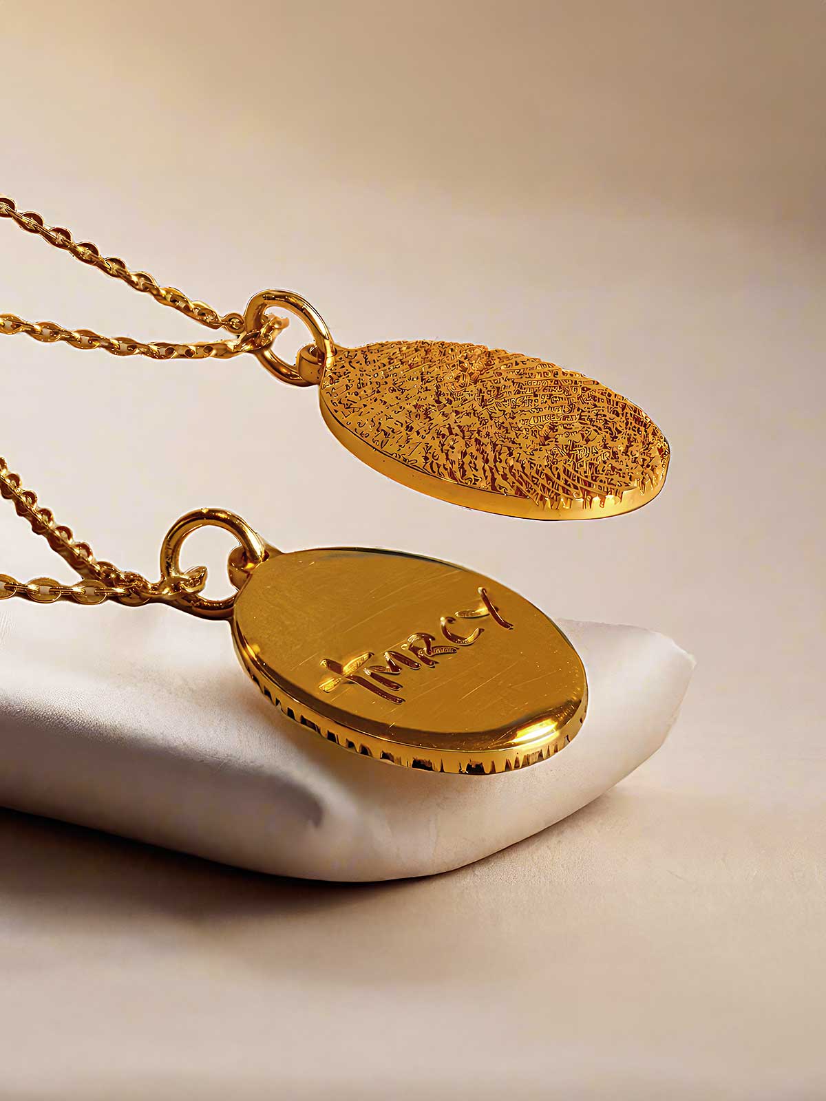 a gold plated necklace on a white cloth