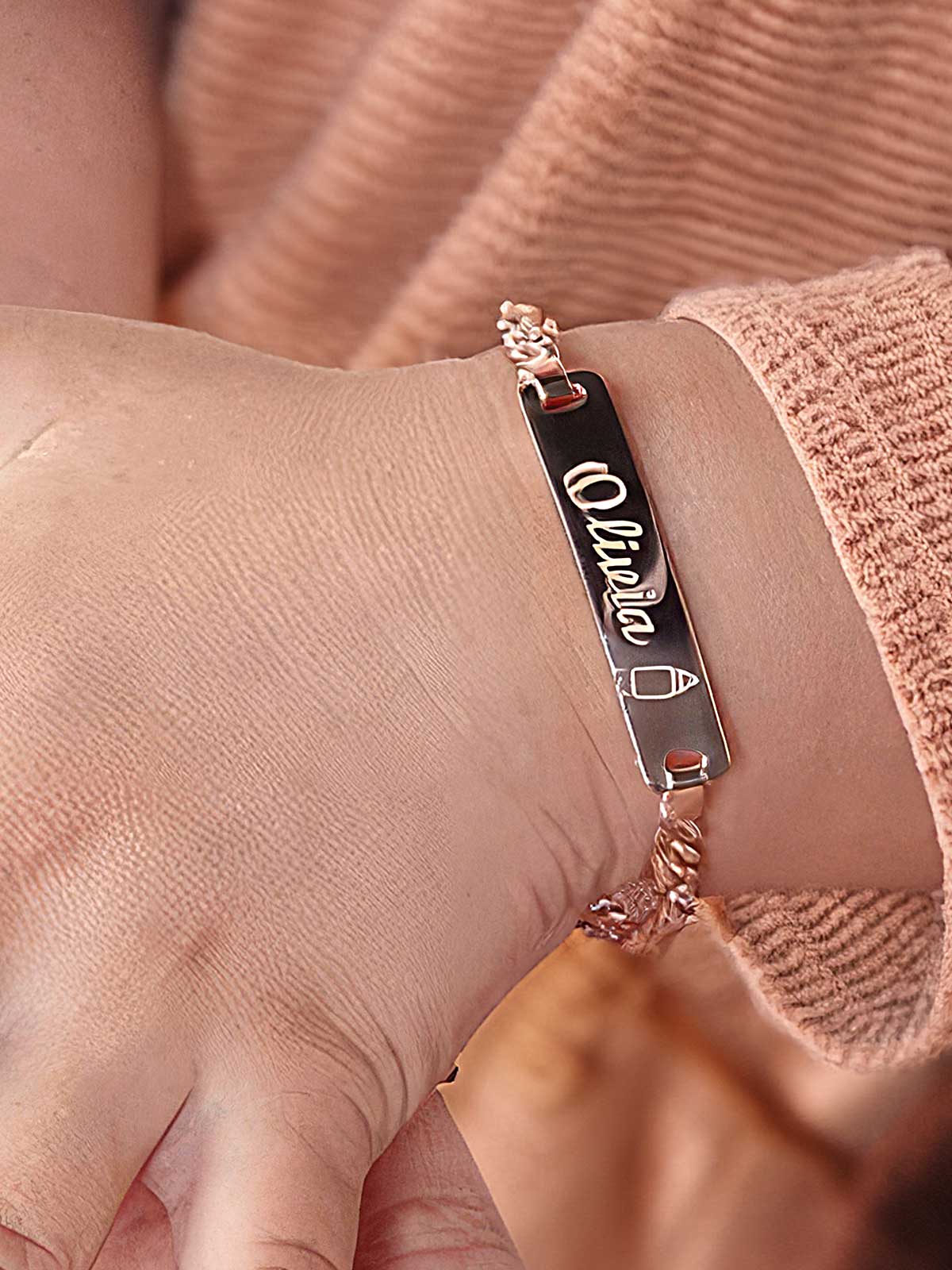 a person wearing a bracelet with a name tag on it