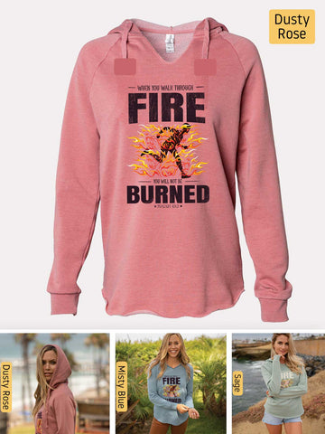 a woman wearing a pink hoodie with a fire burned on it