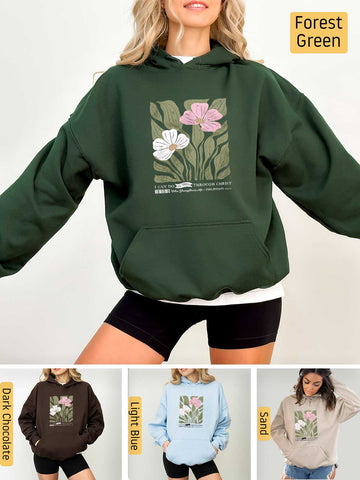a woman wearing a green hoodie with flowers on it
