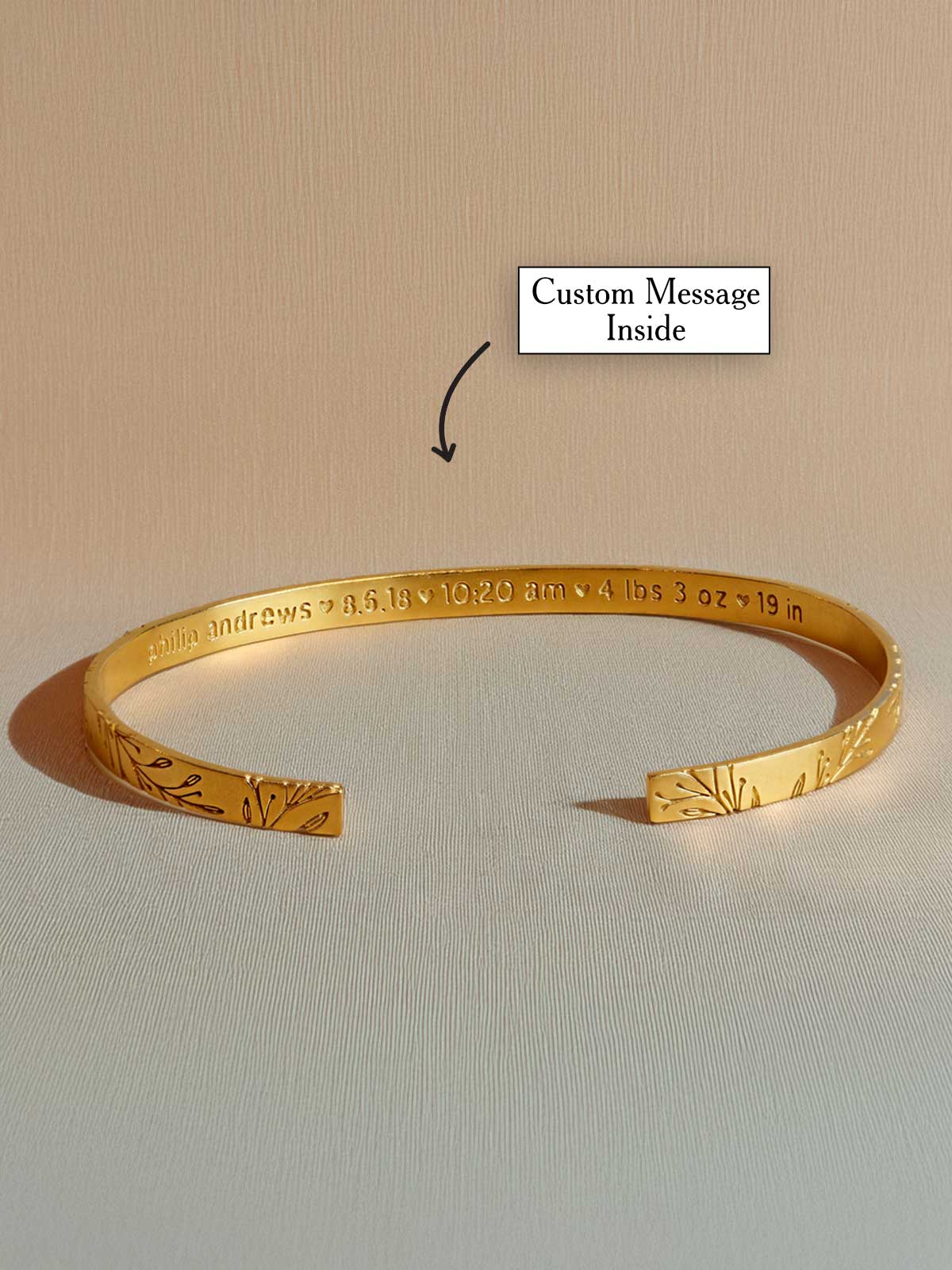 a gold bracelet with a message written on it