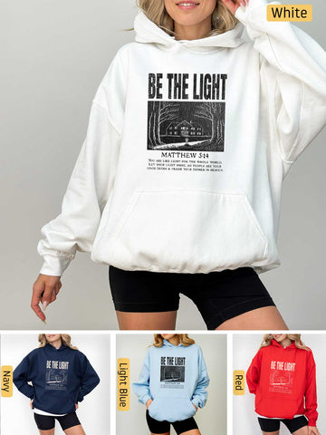 a woman wearing a white hoodie with the words be the light on it