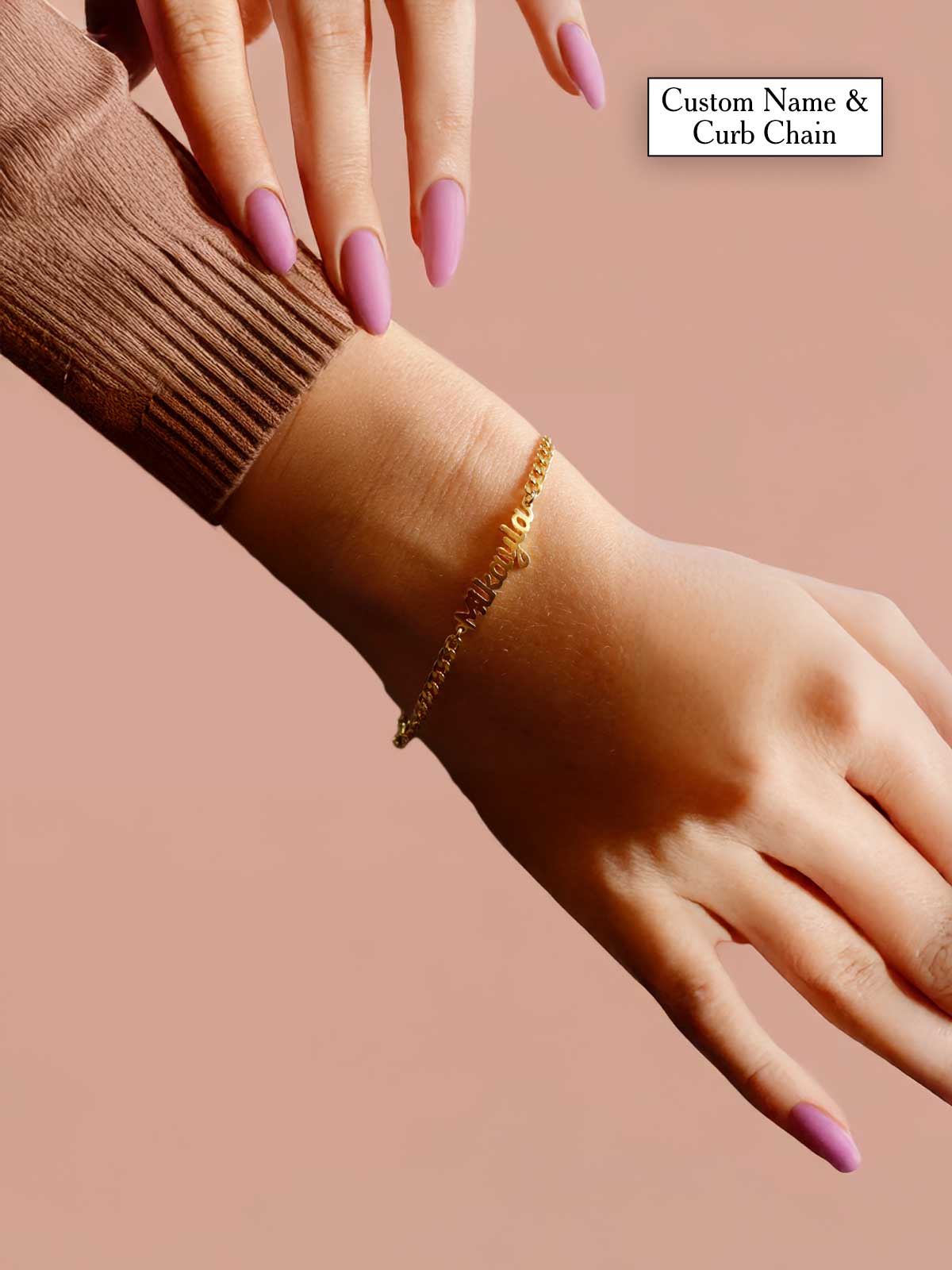 a woman's hand with a gold bracelet on it