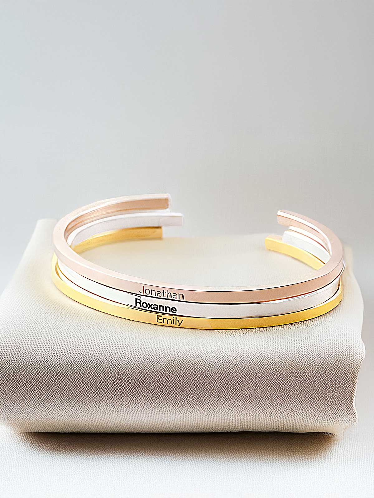 a pair of bracelets sitting on top of a white cloth