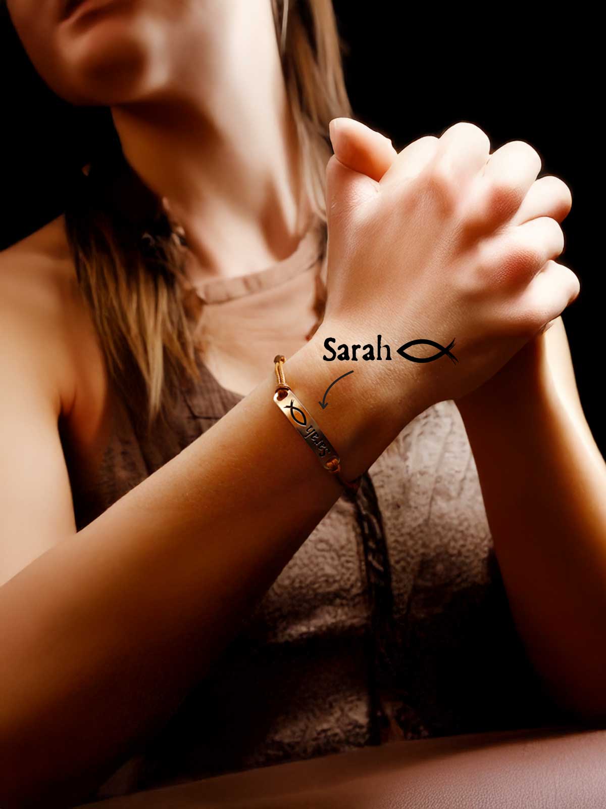 a woman wearing a bracelet with a cross on it