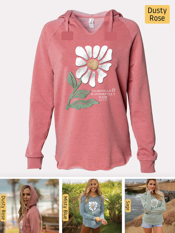 a woman wearing a pink sweatshirt with a flower on it