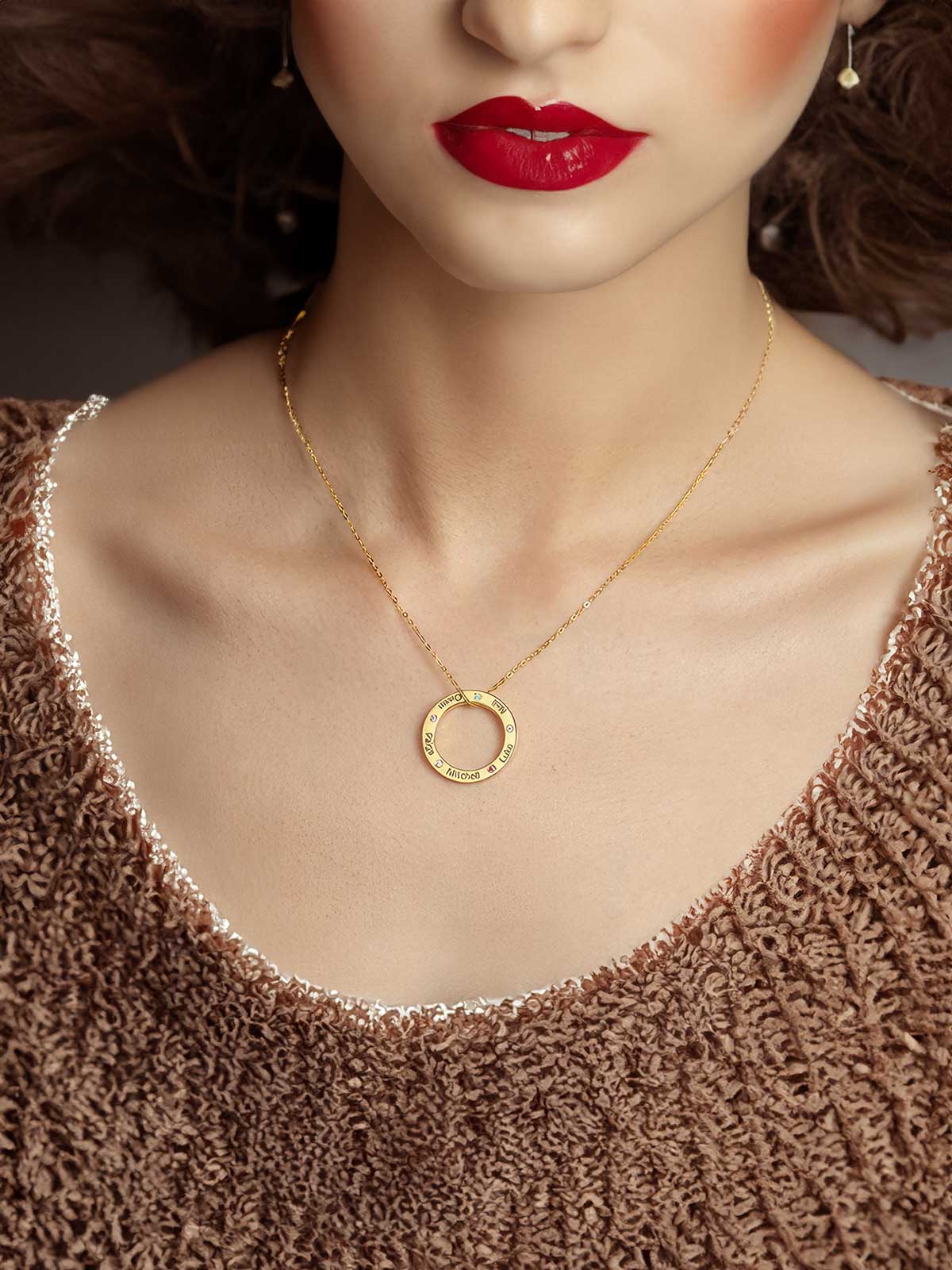 a woman wearing a necklace with a circle on it