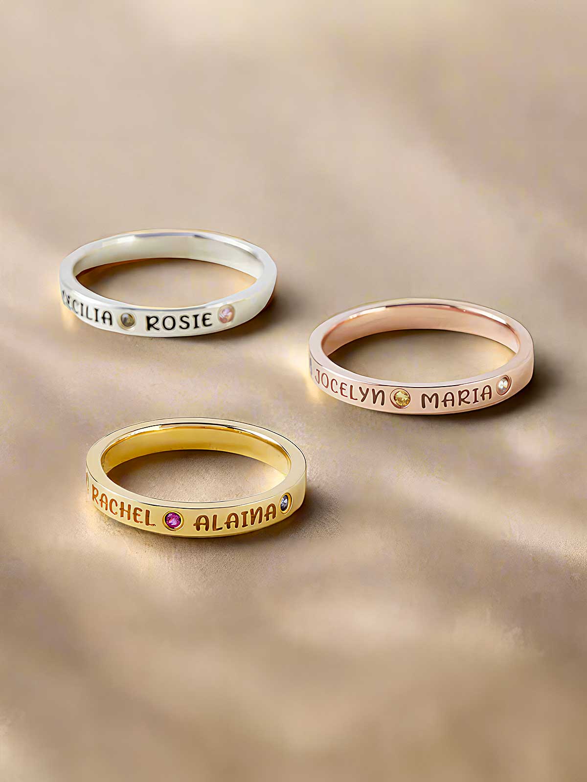 three different types of rings with names on them