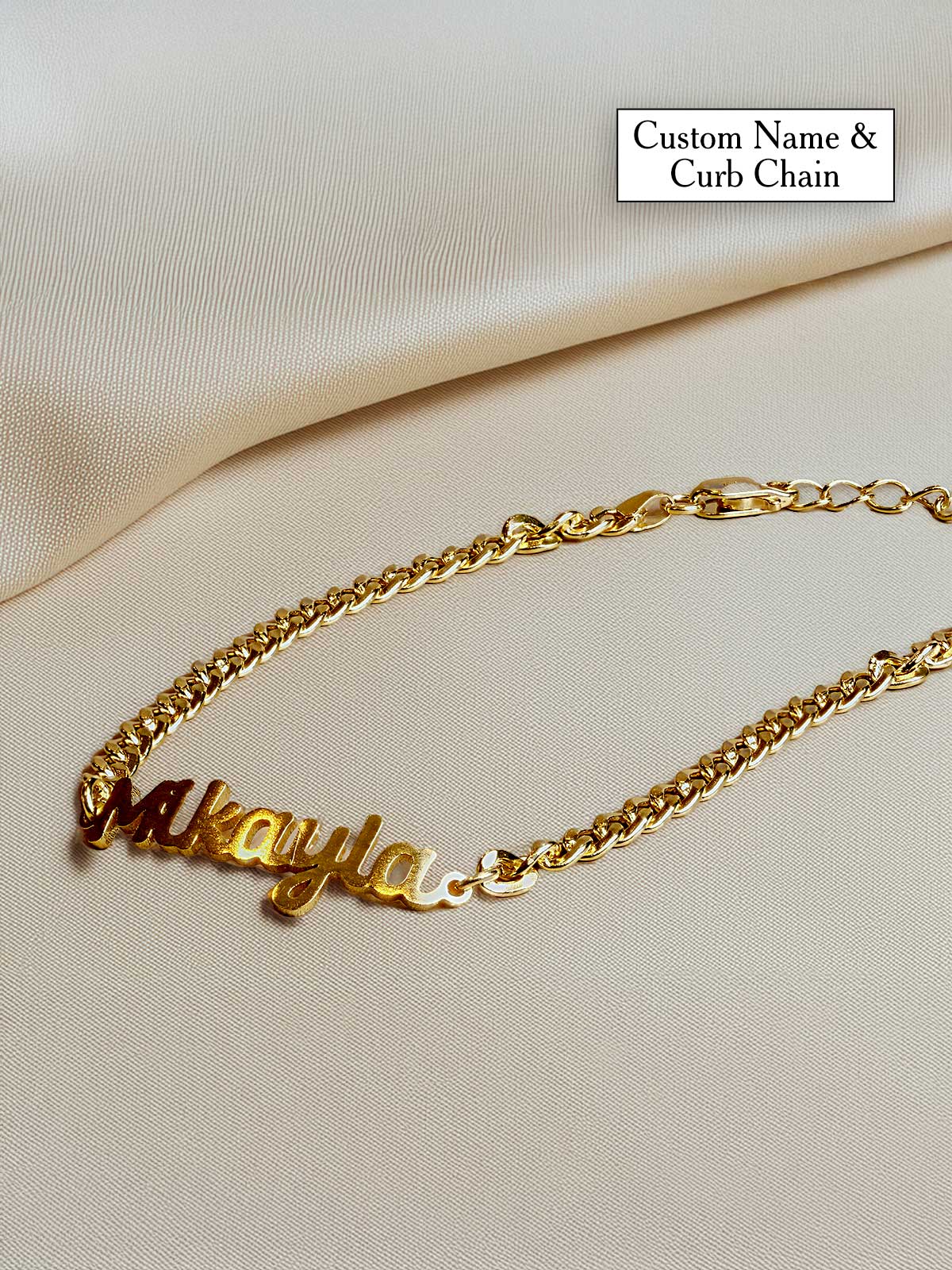 a gold chain bracelet with a name on it