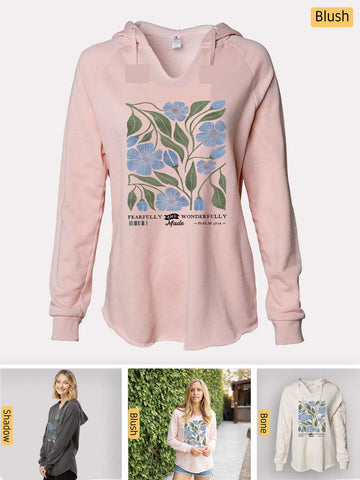 a pink sweatshirt with a blue flower on it