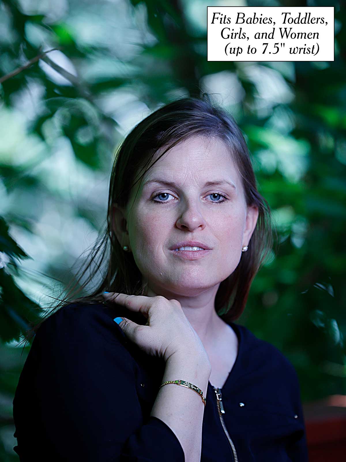 a woman is posing for a picture in front of a tree