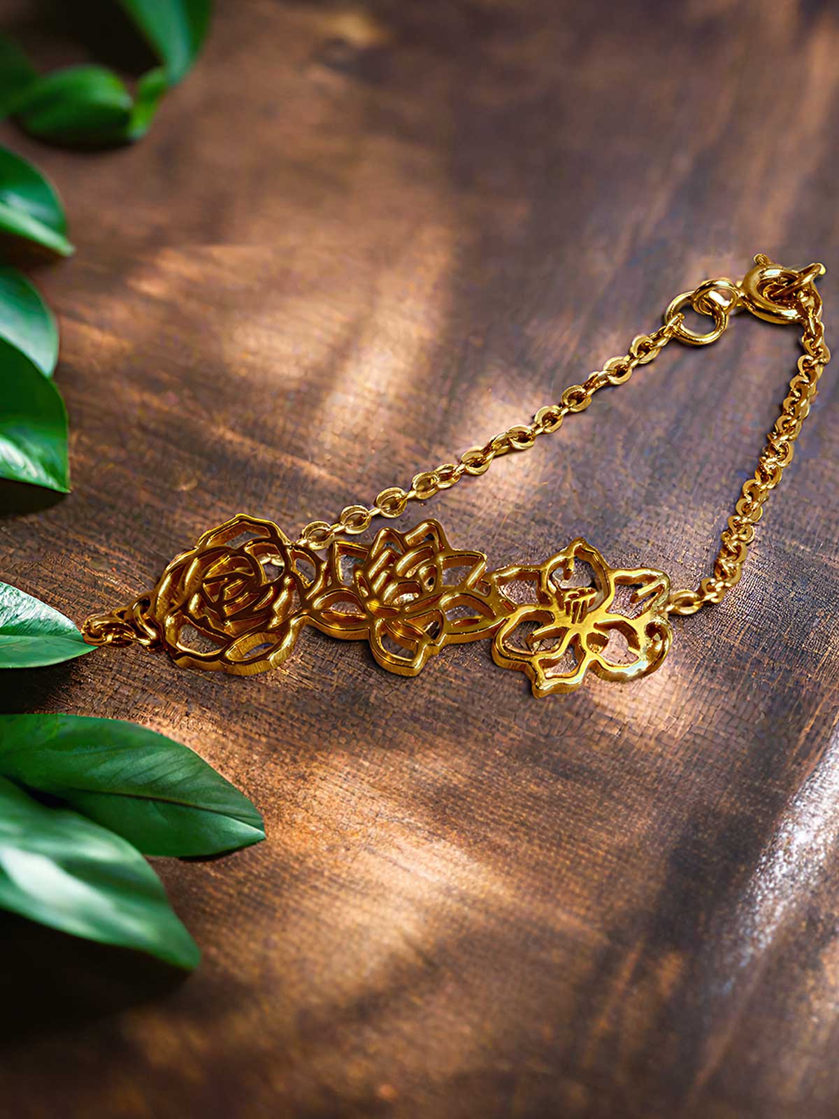 a close up of a gold necklace on a wooden surface