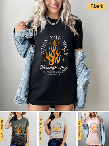 a woman wearing a t - shirt that says when you drink through fire