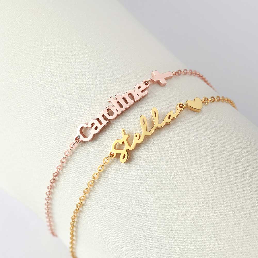 two personalized name bracelets on a white surface