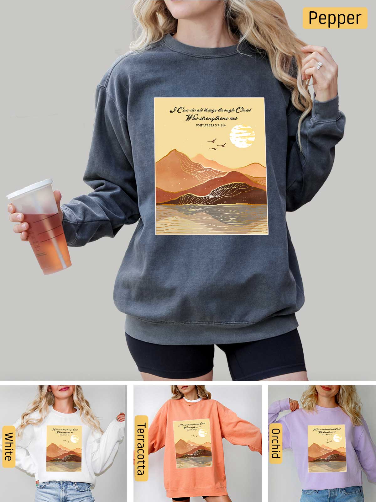 a woman wearing a sweatshirt that has a picture of a mountain on it