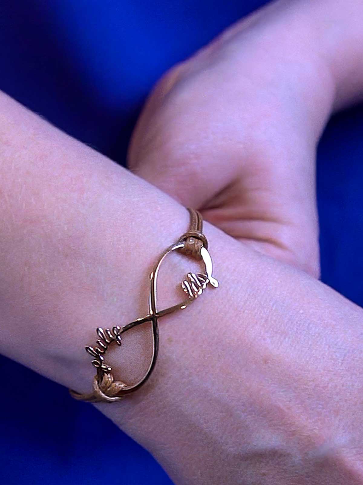 a woman's arm with a gold bracelet on it