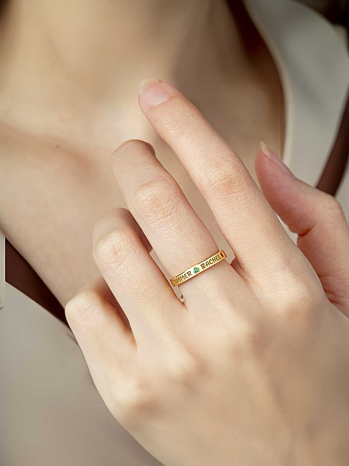 a close up of a person wearing a gold ring