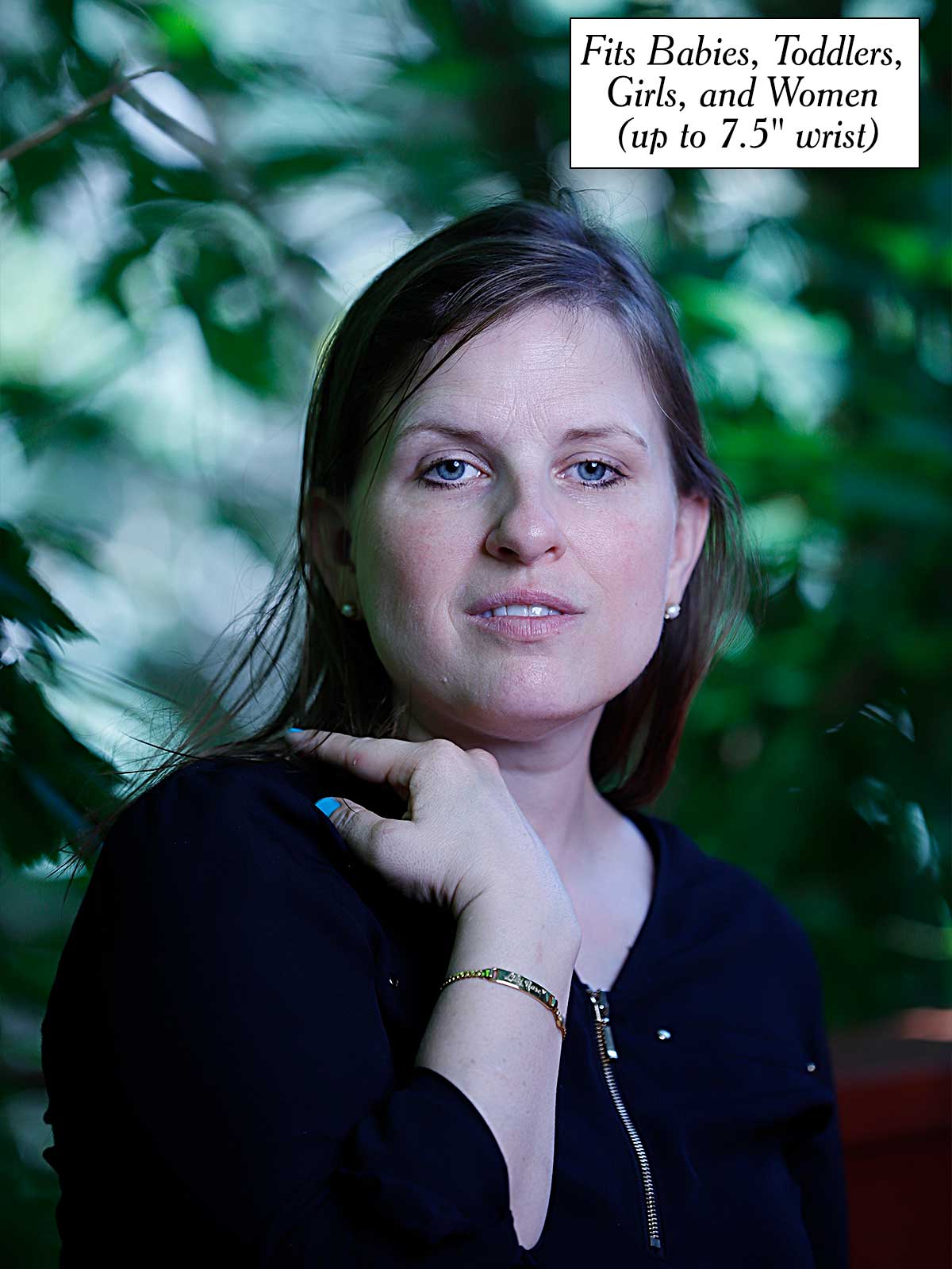 a woman is posing for a picture in front of a tree