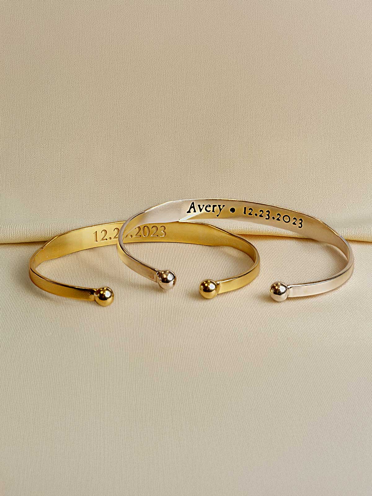 two personalized bracelets on a white surface