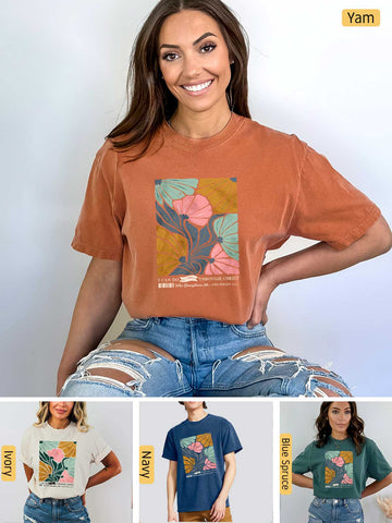 a woman wearing a t - shirt that has a picture of a tree on it