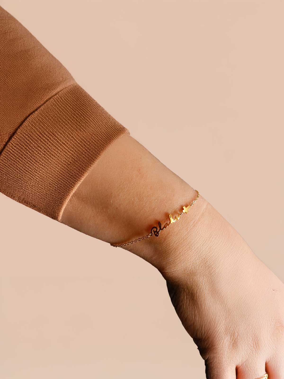 a woman's arm with a gold bracelet on it