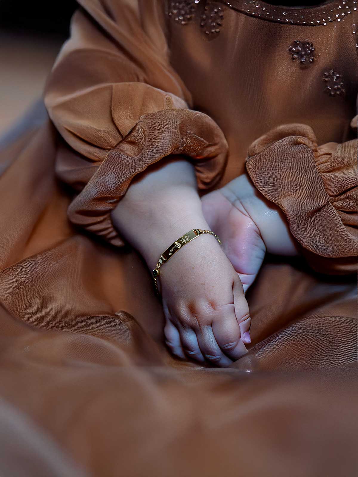 a close up of a child's hand on a bed